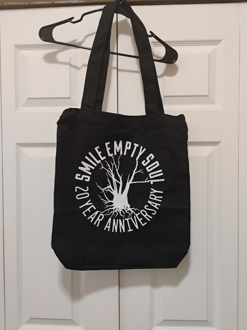 Smile Empty Soul 20th Anniversary Black Graphic Tote Bag with White Tree Print